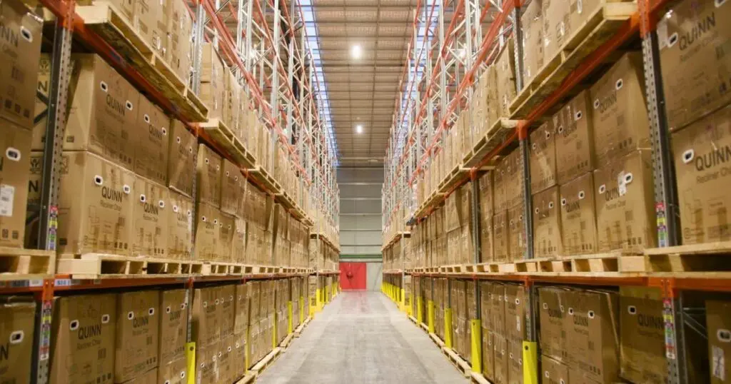 A well-organized warehouse aisle with inventory racks and logistics software improving efficiency