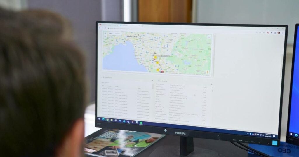 man engaged in utilizing logistics software on computer, demonstrating the integral role of technology in modern logistics management