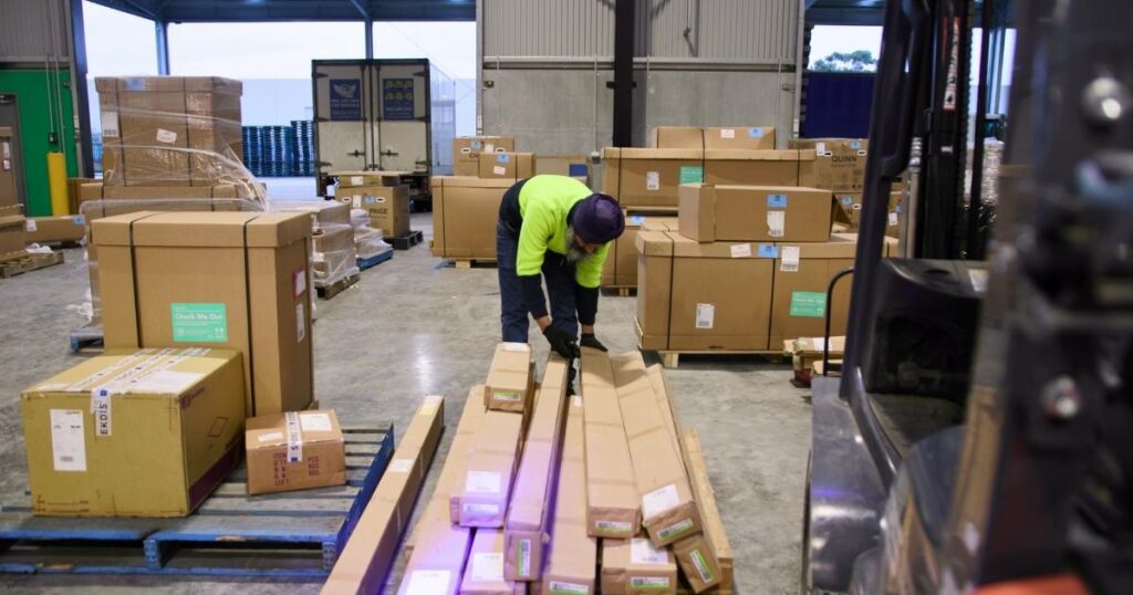 worker sorting and organizing packages, exemplifying practical logistics tasks