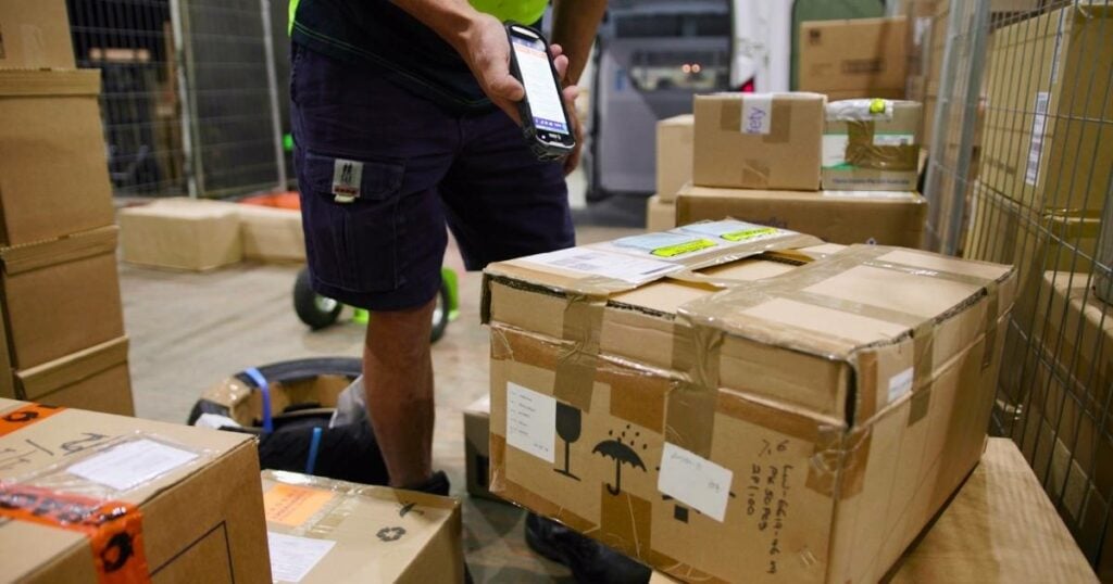 Man scanning a package for precise logistics tracking