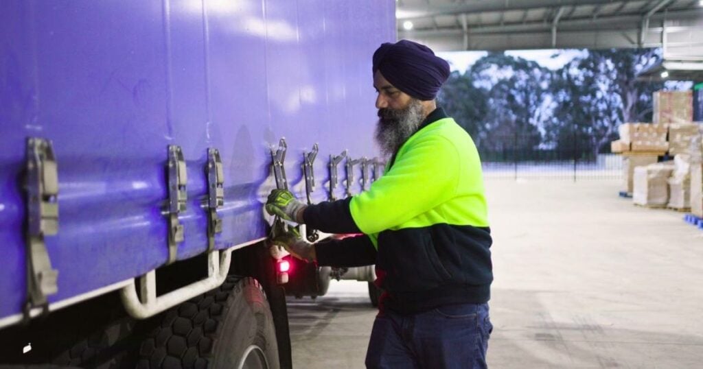 delivery man preparing truckload for dispatch