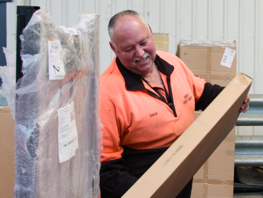 Delivery Man Organizing and Categorizing Packages in a Logistics Facility