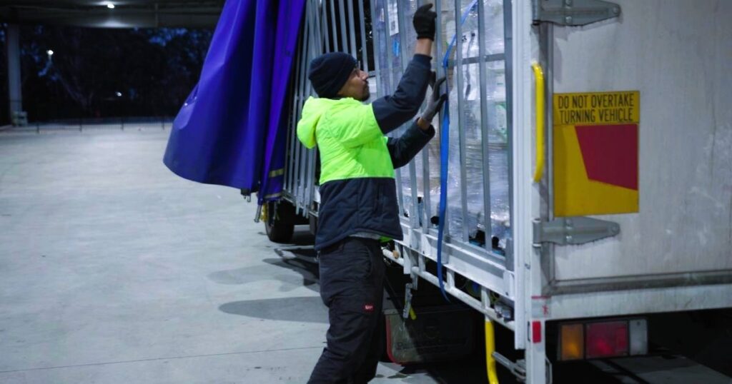 outbound logistics delivery man sorting parcels boxes for dispatch truckload