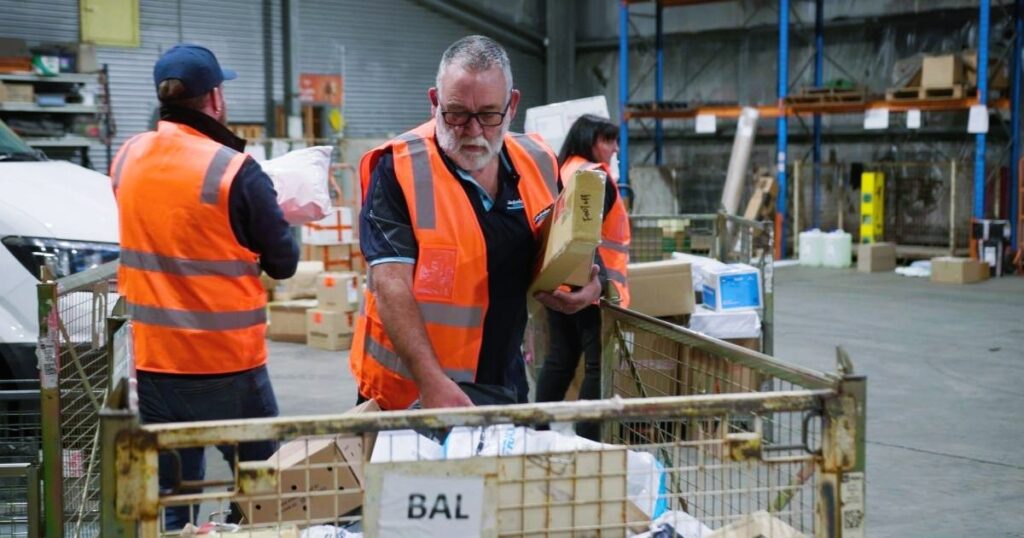 delivery man arranging parcels for delivery cod package cash on delivery