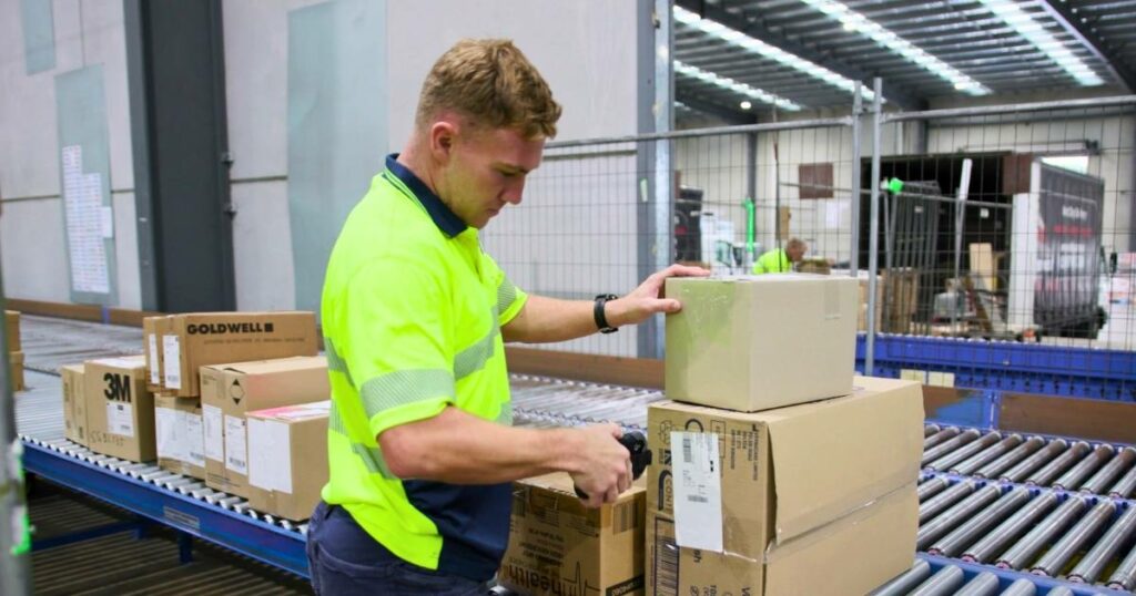 warehouse staff scanning boxes for delivery dispatch