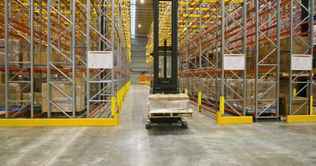 Fully loaded forklift navigating a warehouse aisle, exemplifying efficient logistics operations