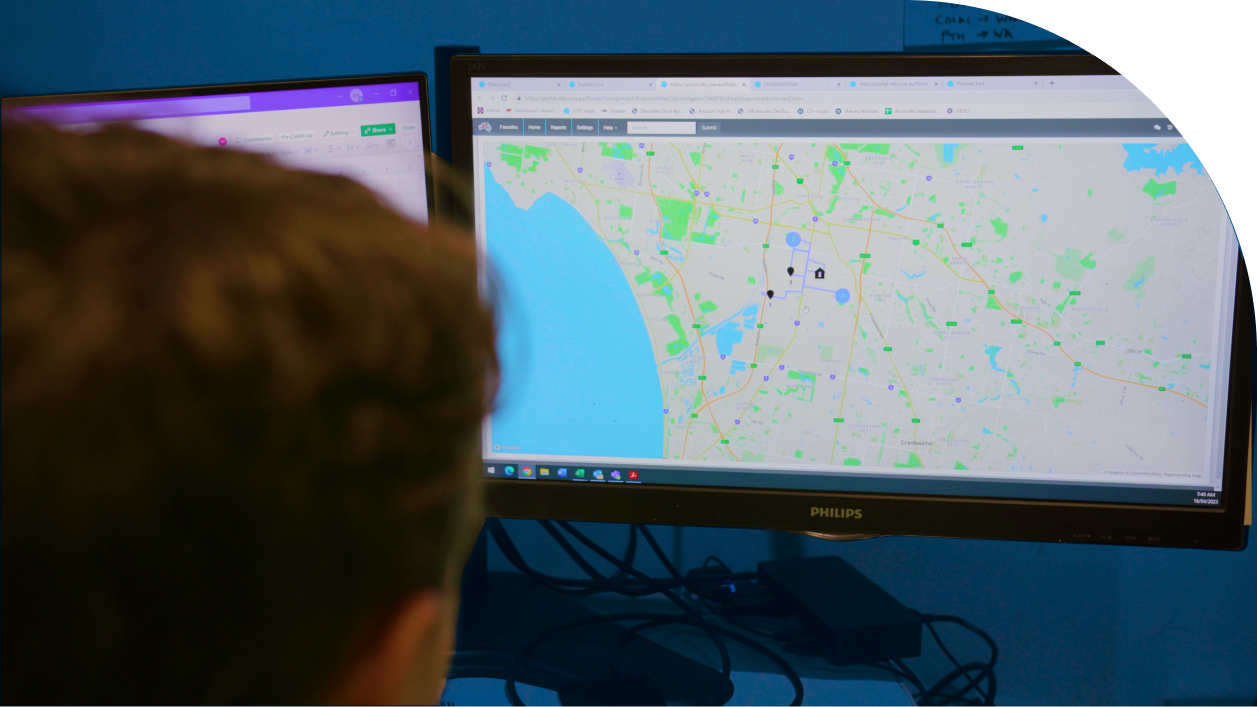 man engaged in utilizing logistics software on computer, demonstrating the integral role of technology in modern logistics management