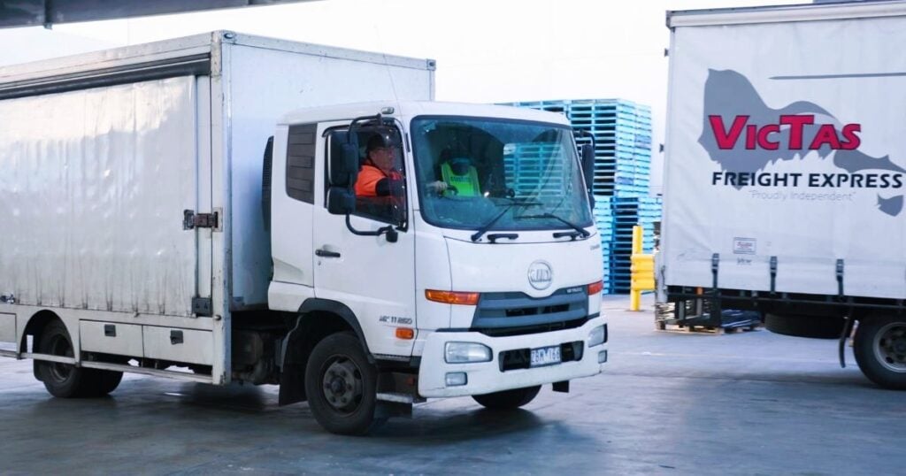 delivery truck leaving warehouse for area dispatch