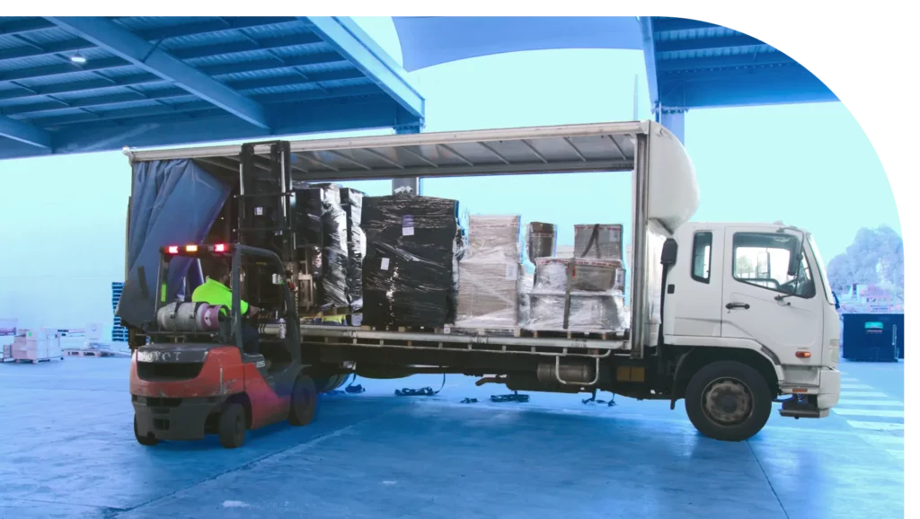 man using forklift truck in loading boxes