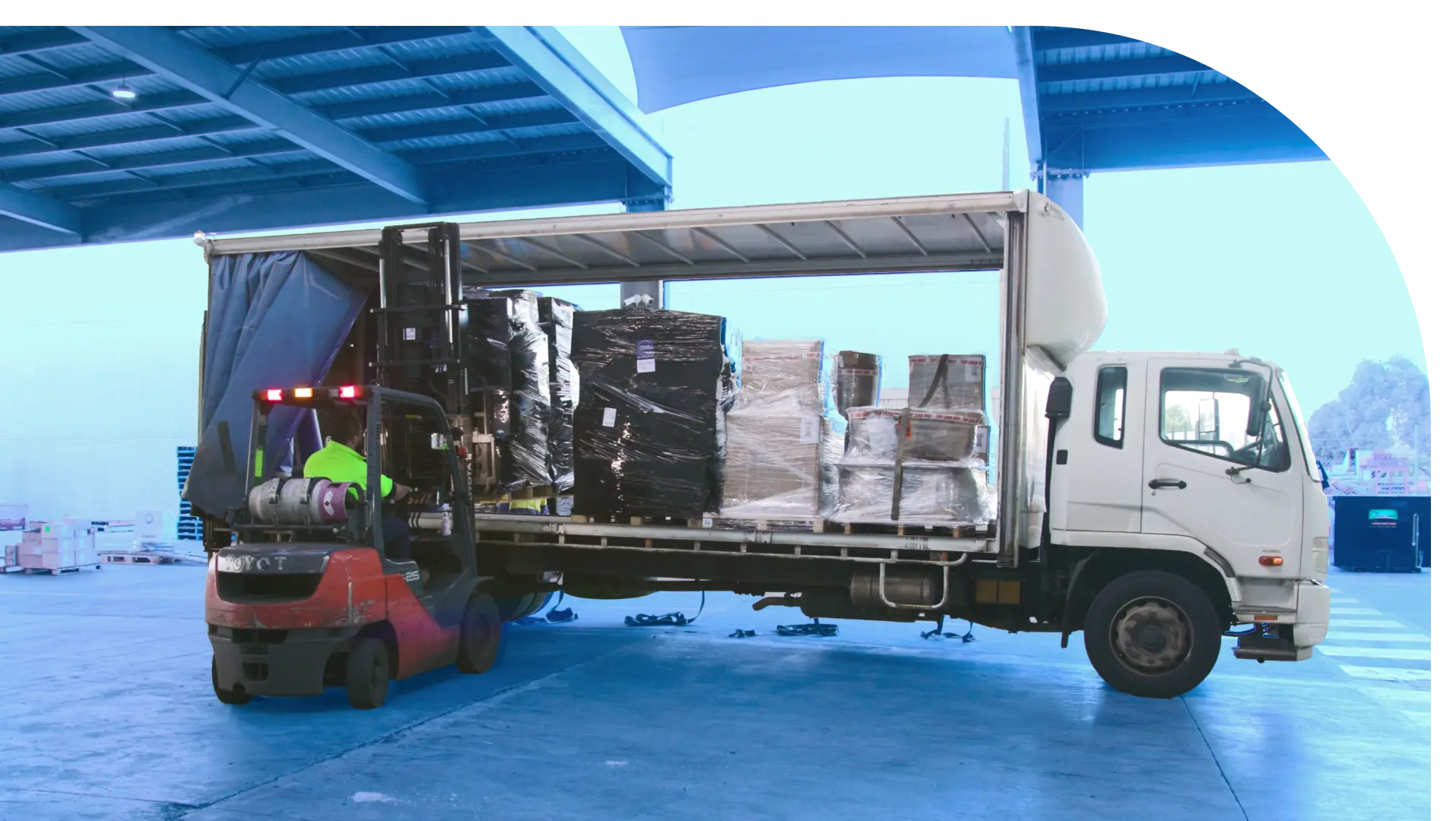 man using forklift truck in loading boxes