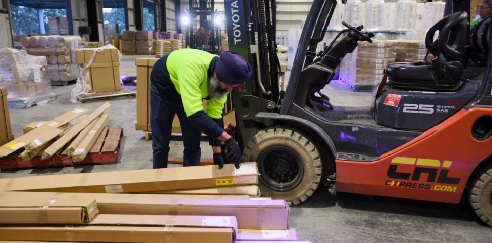 man efficiently scanning packages with logistics software, ensuring precise tracking and management of shipments within the supply chain