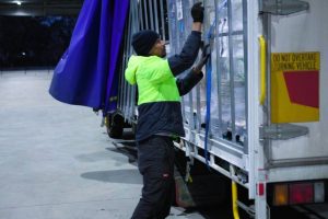 outbound logistics delivery man sorting parcels boxes for dispatch truckload