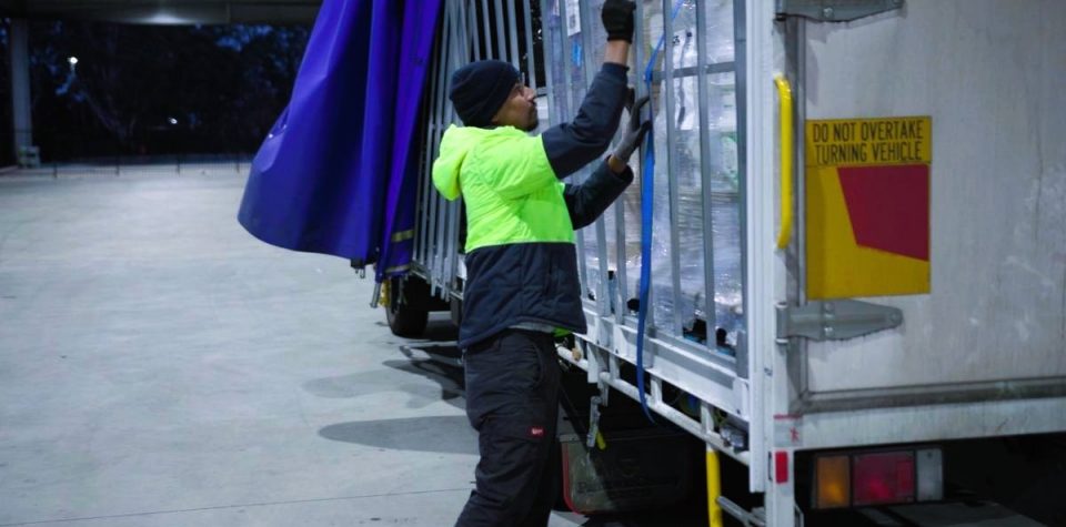 outbound logistics delivery man sorting parcels boxes for dispatch truckload