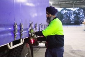 delivery man preparing truckload for dispatch