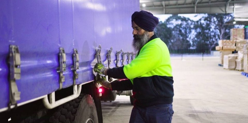 delivery man preparing truckload for dispatch