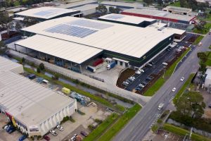 Aerial view of a warehouse with logistics in action: pallets, forklifts, and organized inventory