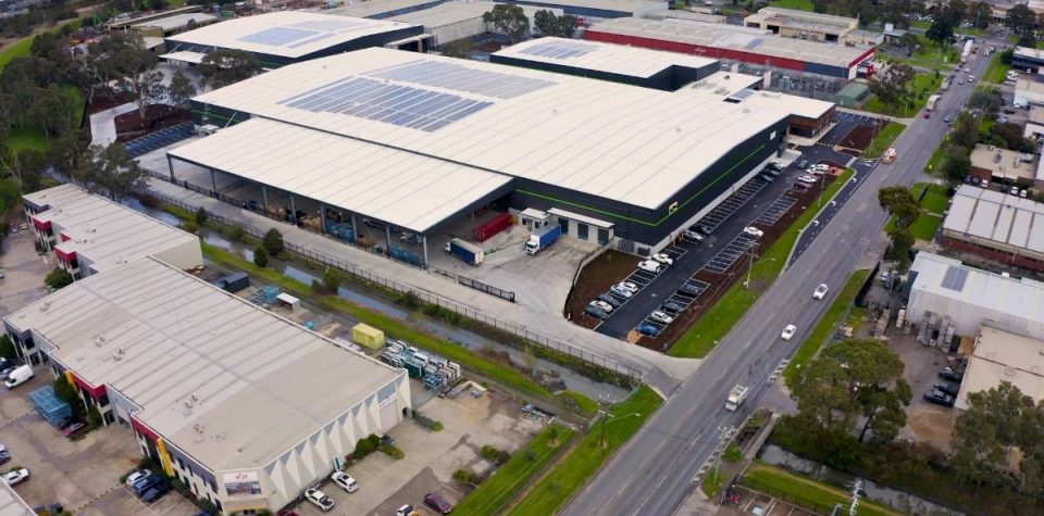 Aerial view of a warehouse with logistics in action: pallets, forklifts, and organized inventory