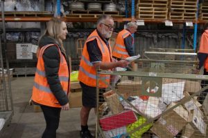 Logistics team members collaboratively sorting and processing incoming packages, demonstrating efficient logistics workflow