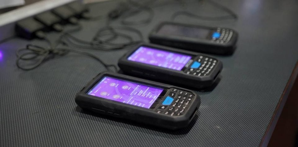 A row of digital scanners neatly lined up, essential tools in logistics and inventory management