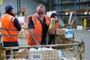 delivery man arranging parcels for delivery cod package cash on delivery