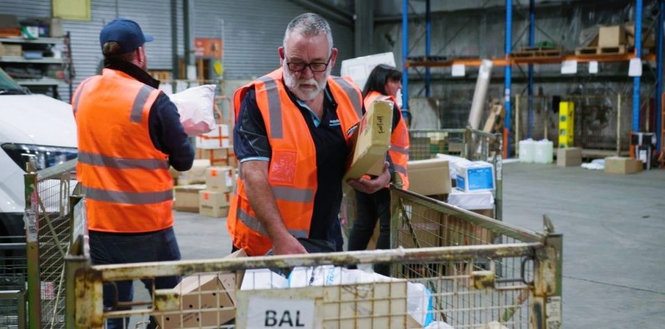 delivery man arranging parcels for delivery cod package cash on delivery