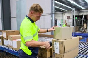 warehouse staff scanning boxes for delivery dispatch