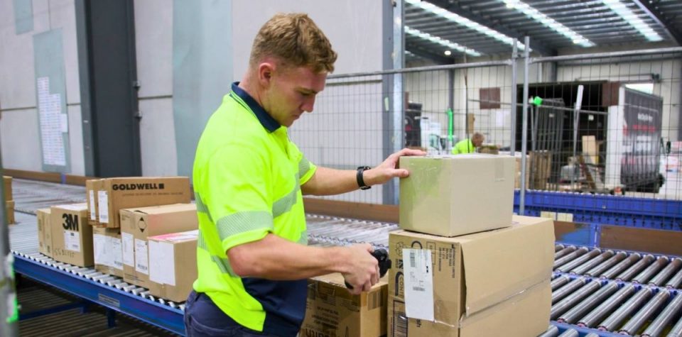 warehouse staff scanning boxes for delivery dispatch