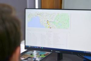 man engaged in utilizing logistics software on computer, demonstrating the integral role of technology in modern logistics management