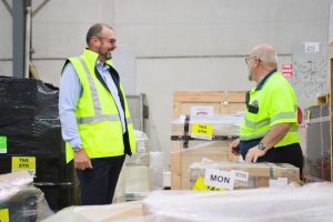 Warehouse personnel engaged in a logistics discussion, optimizing operations for efficiency