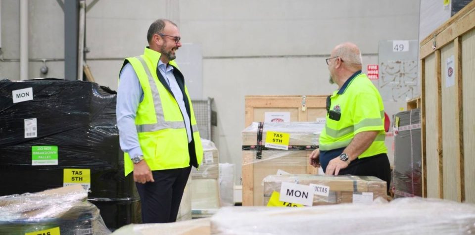 Warehouse personnel engaged in a logistics discussion, optimizing operations for efficiency